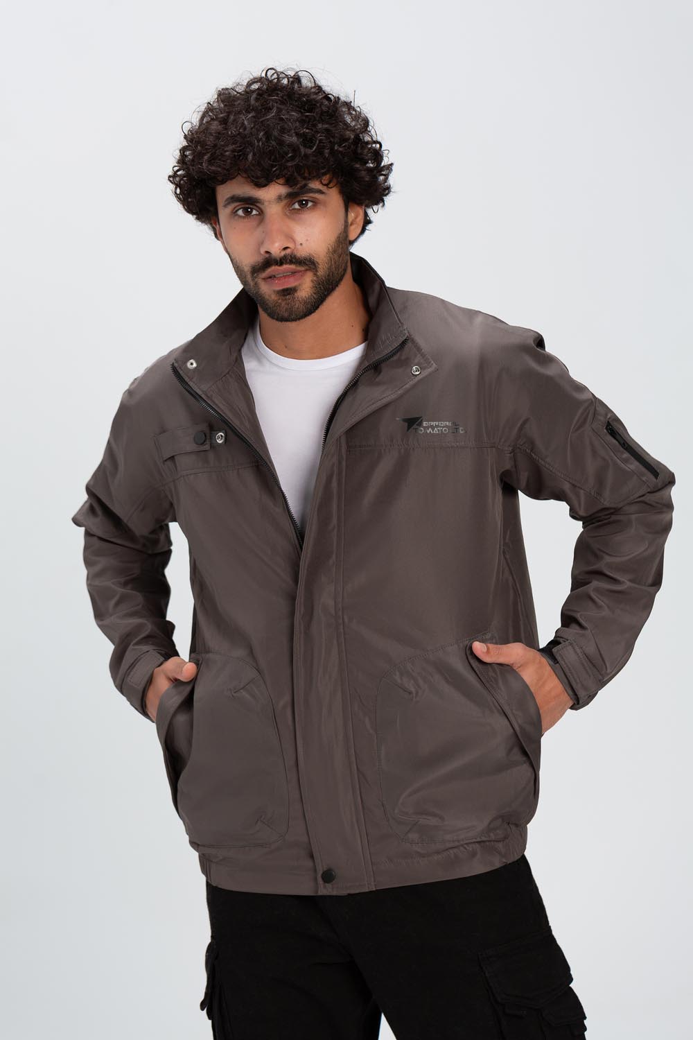 Men's casual brown waterproof jacket with a full zipper, stand collar, and unique pocket details.