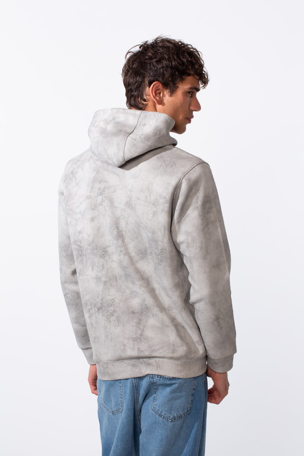 Men's tie-dye long sleeve slim fit hood sweatshirt in grey and white with blue jeans.