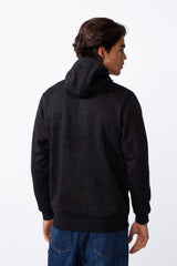Rear view of a man wearing a black washed effect slim fit full zip hooded sweatshirt and blue jeans.