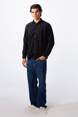 Men's velvet slim fit striped long sleeve winter shirt in black paired with blue jeans.