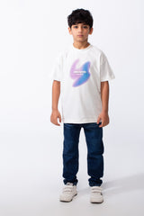 A boy wears a white ribbed crew neck t-shirt with a purple and blue graphic and dark blue jeans.