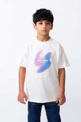 A boy wears a white ribbed crew neck t-shirt with a purple and blue graphic and typography.