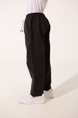 بنطال رياضي واسع بحبل للربط للأولاد بألوان أساسية مع جيب خلفي