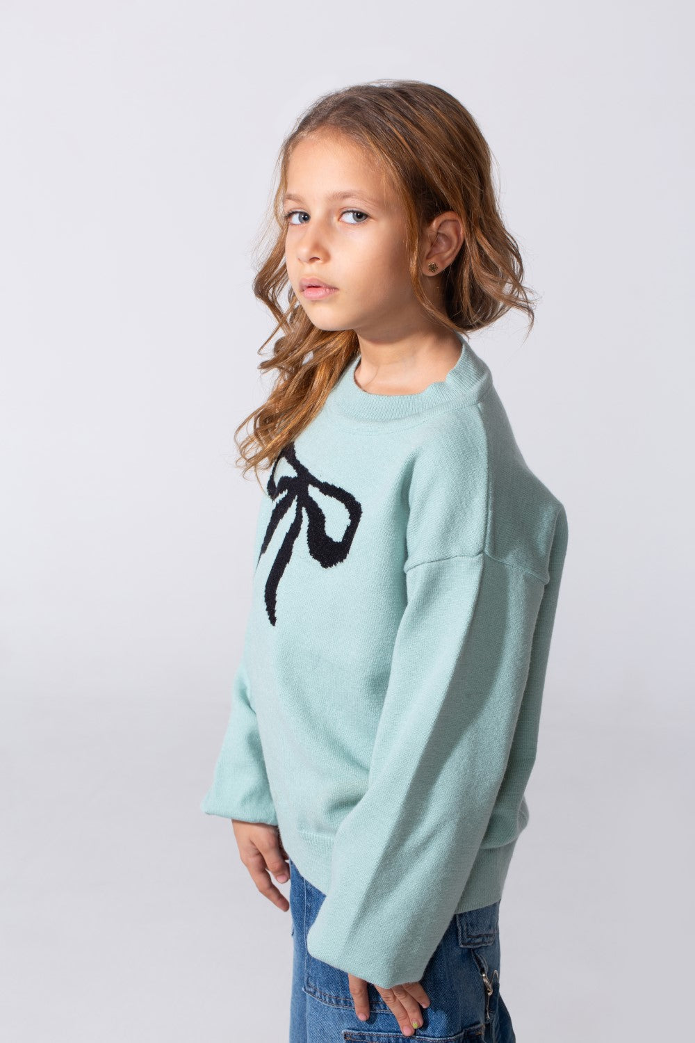 Girl's Long Sleeved Pullover With A Bow Print On The Front And A Round Neck