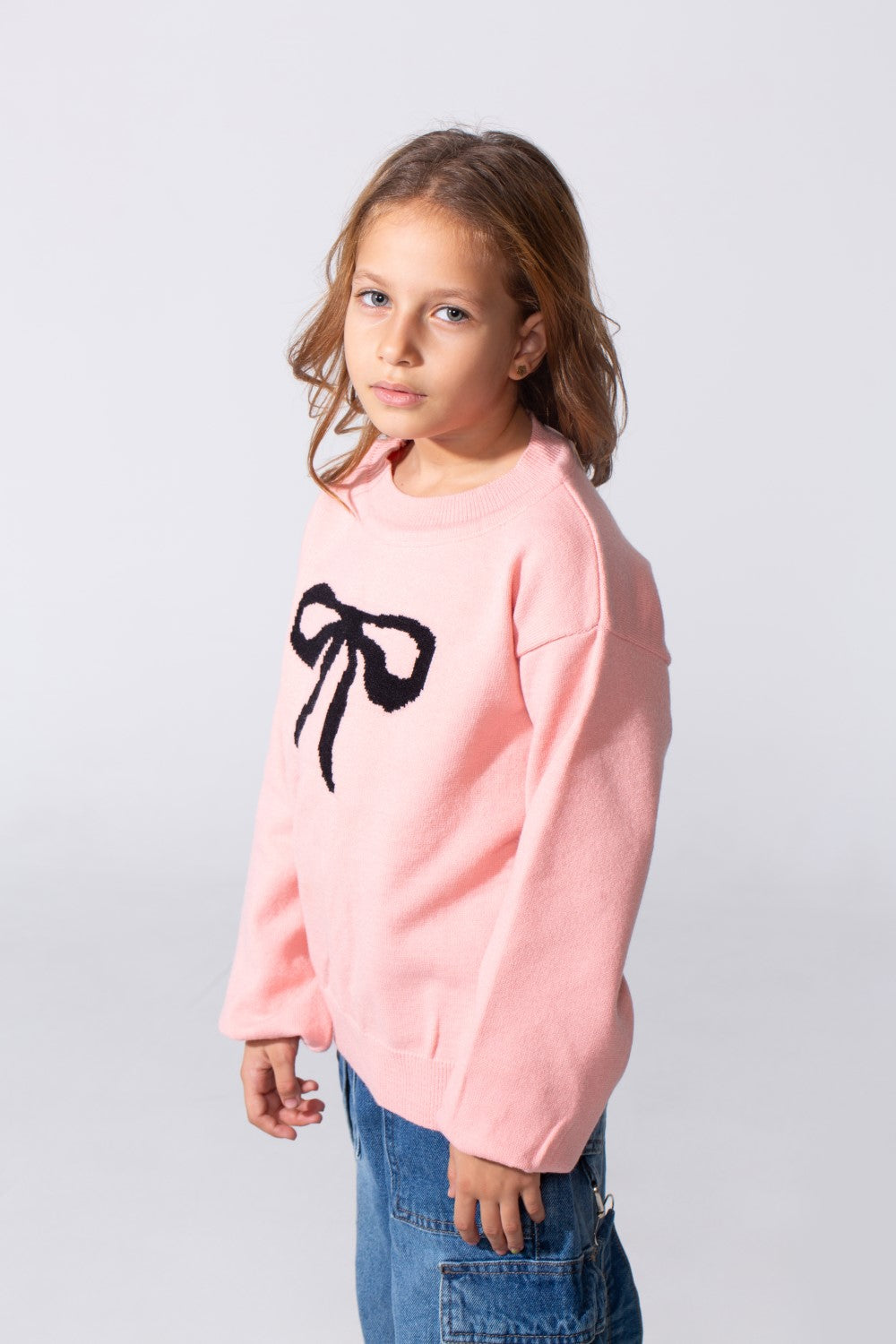 Girl's Long Sleeved Pullover With A Bow Print On The Front And A Round Neck