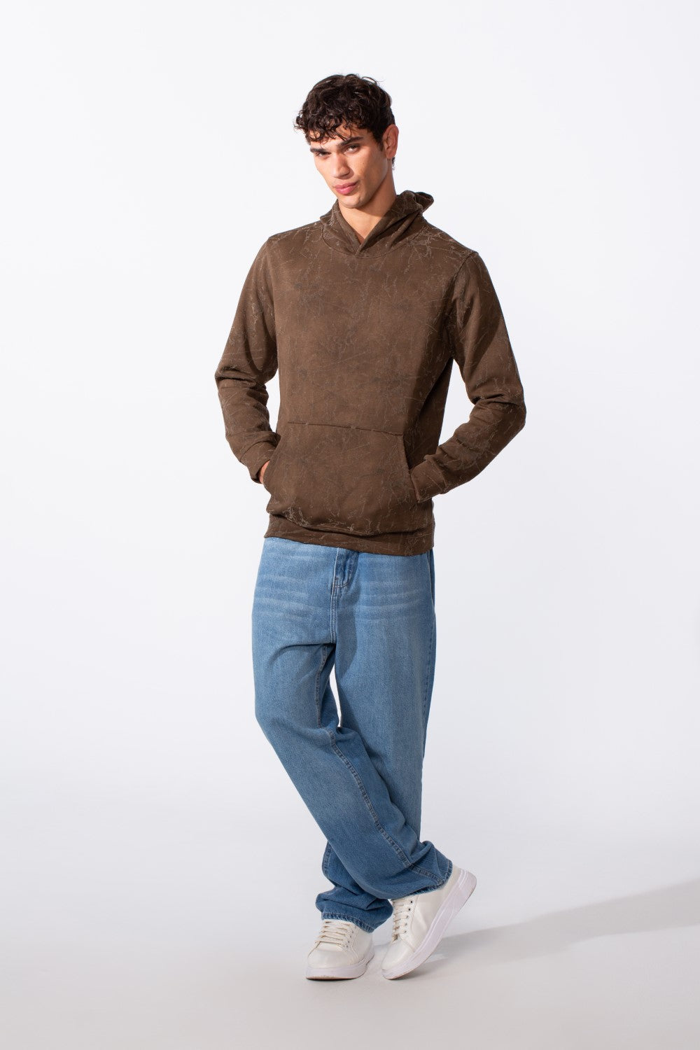 Men's tie-dye long sleeve slim fit brown hoodie paired with blue jeans and white sneakers.