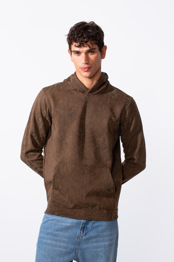 Men's tie-dye long sleeve slim fit hood sweatshirt in brown paired with blue jeans.