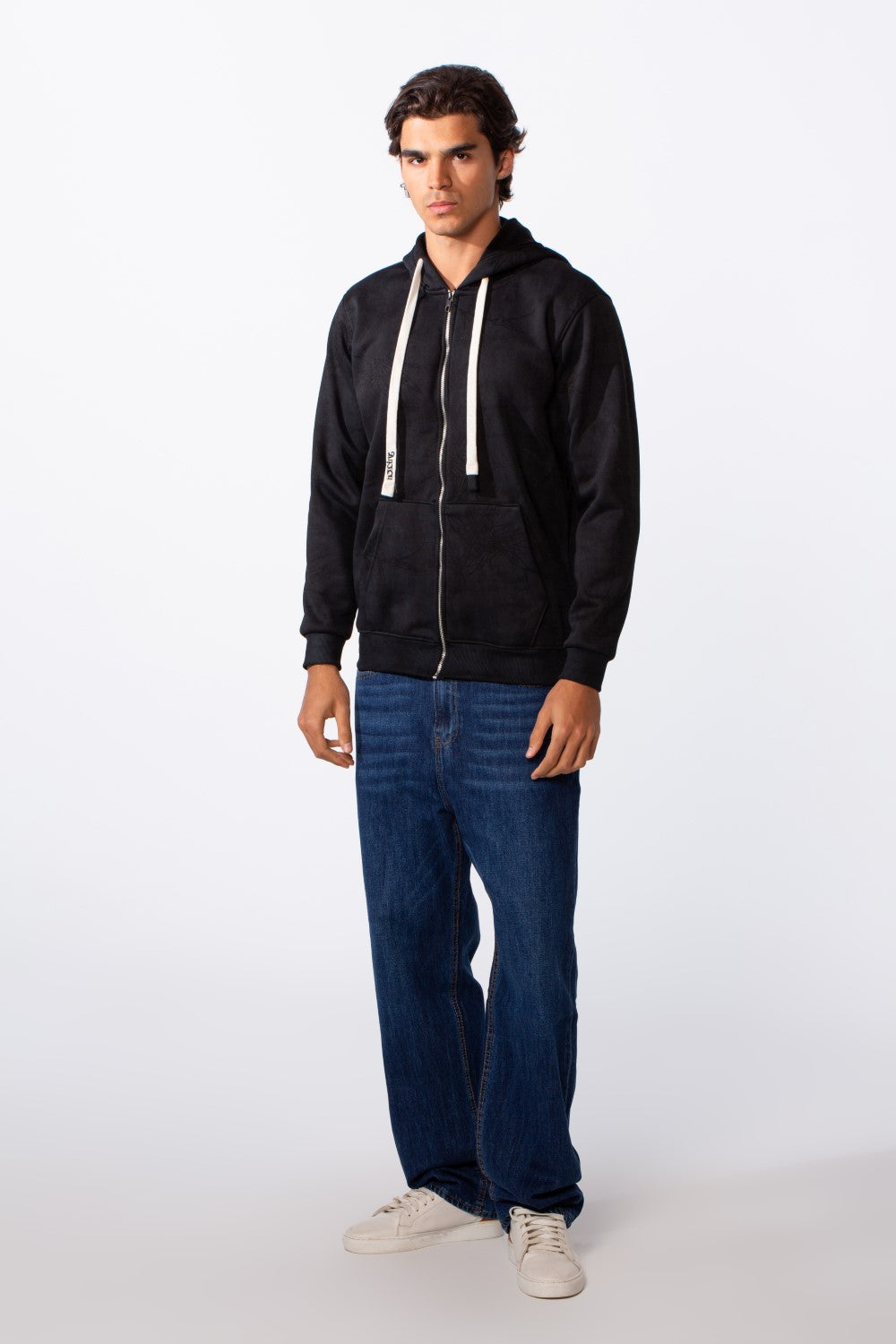 Men's washed effect slim fit full zip black hoodie with white drawstrings and blue jeans.