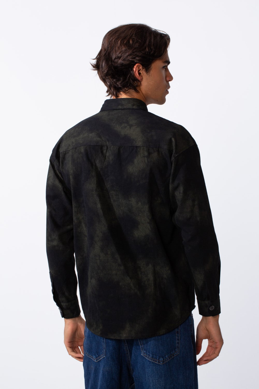 Rear view of a man wearing a black and olive washed gabardine regular fit long-sleeve shirt.