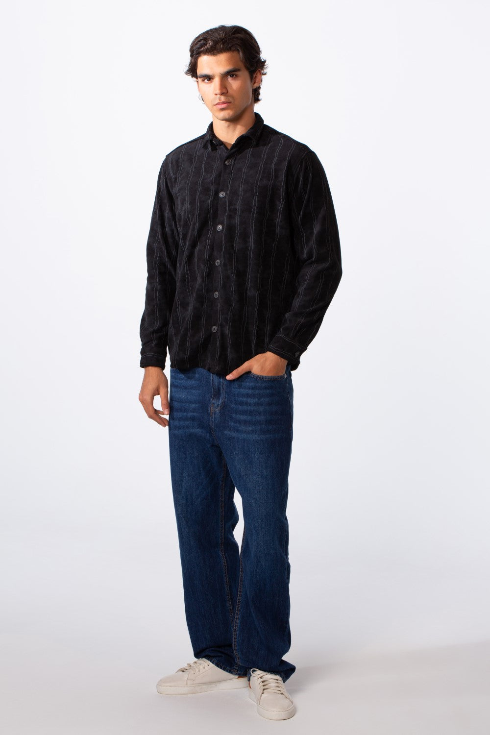 Men's velvet slim fit striped long sleeve winter shirt in black paired with blue jeans.