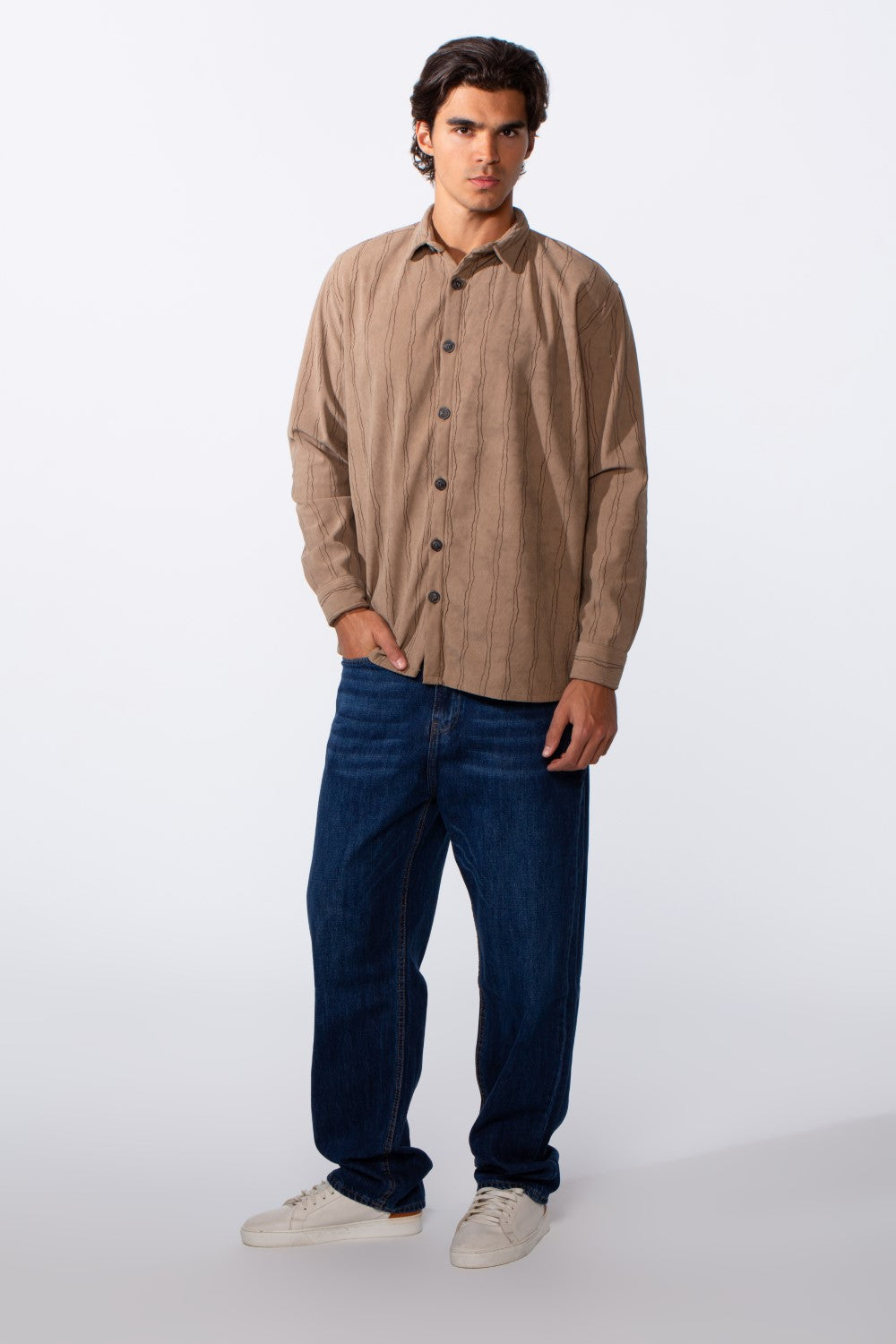 Men's velvet slim fit striped long sleeve winter shirt in tan with dark blue jeans.