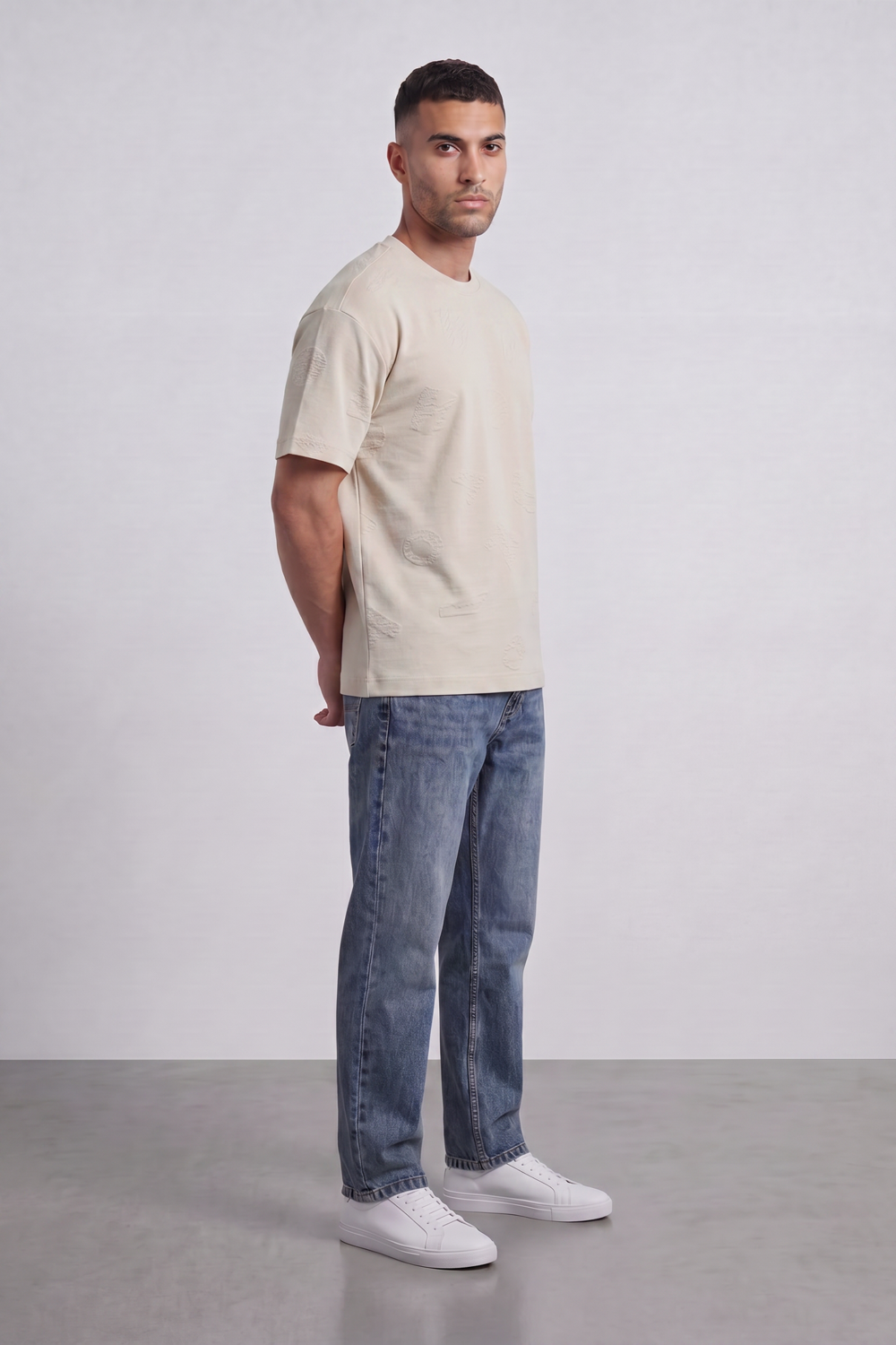 Men’s Tomato Store Ghost Emblem T-Shirt Tonal Raised Symbol Motifs Spread Across A Fine Ripple Surface Relaxed Fit