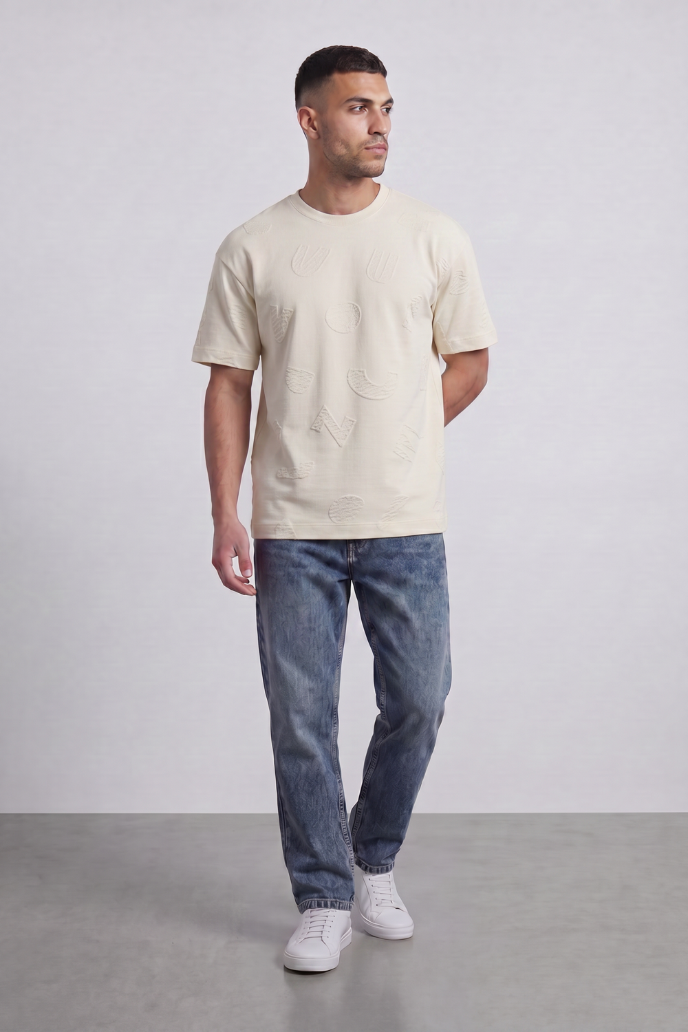 Men’s Tomato Store Ghost Emblem T-Shirt Tonal Raised Symbol Motifs Spread Across A Fine Ripple Surface Relaxed Fit
