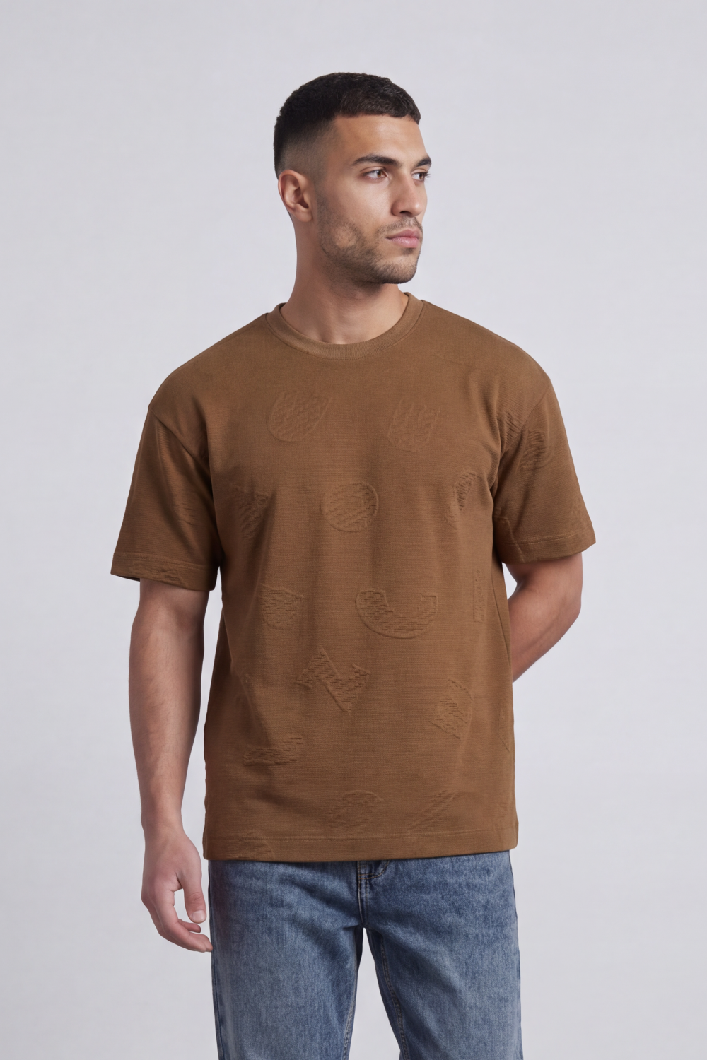 Men’s Tomato Store Ghost Emblem T-Shirt Tonal Raised Symbol Motifs Spread Across A Fine Ripple Surface Relaxed Fit