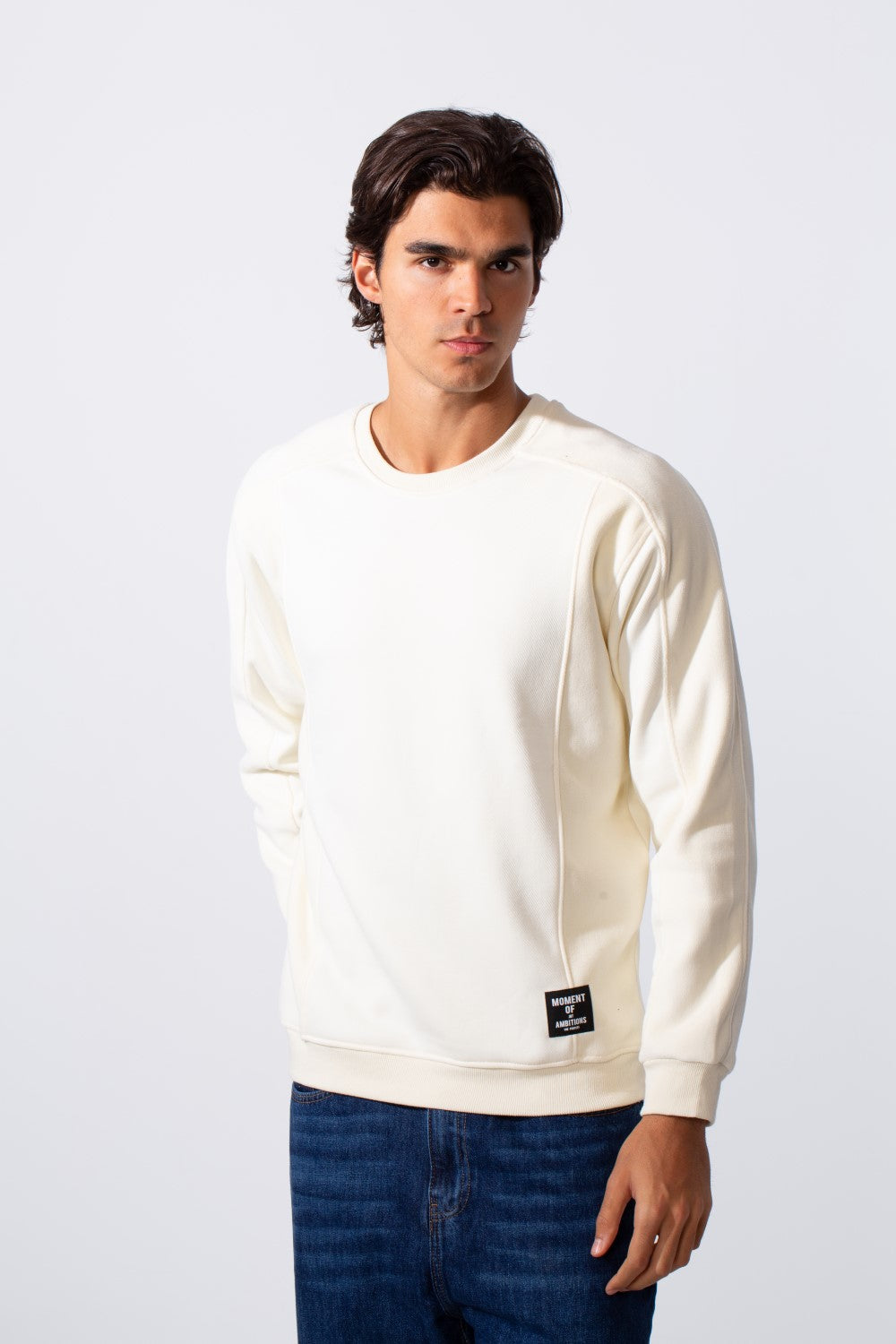 Men's slim fit basic round neck sweatshirt in off-white with a small black logo patch.