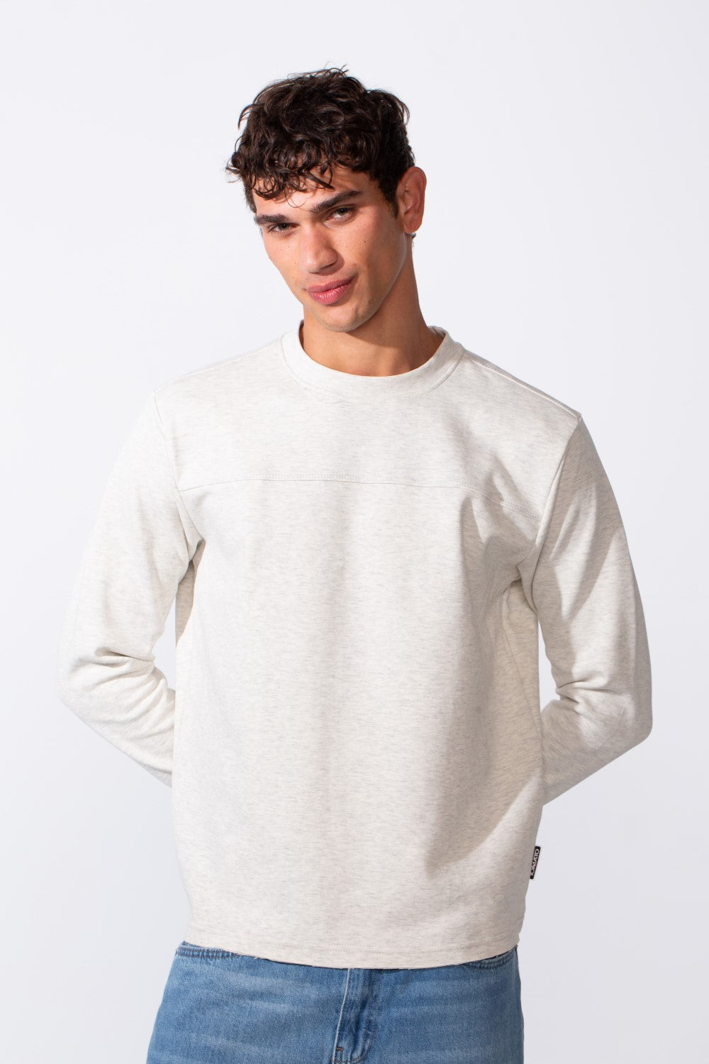 Men's plain essential round neck slim fit sweatshirt in light grey marl with blue jeans.
