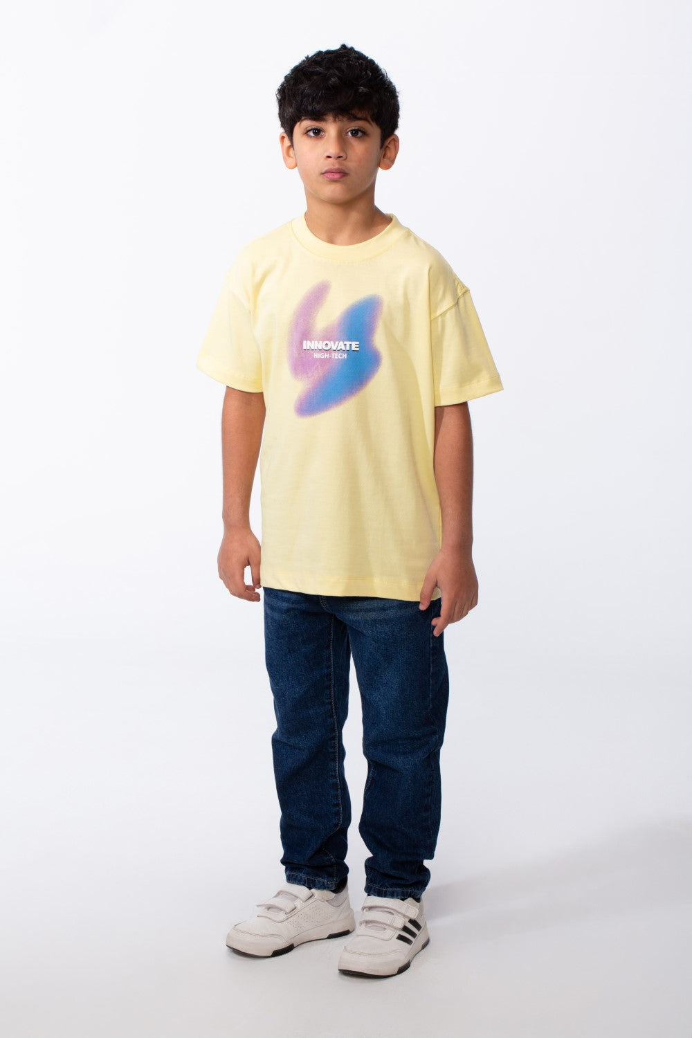 Boy's yellow ribbed crew neck t-shirt with a blue and purple graphic and typography.