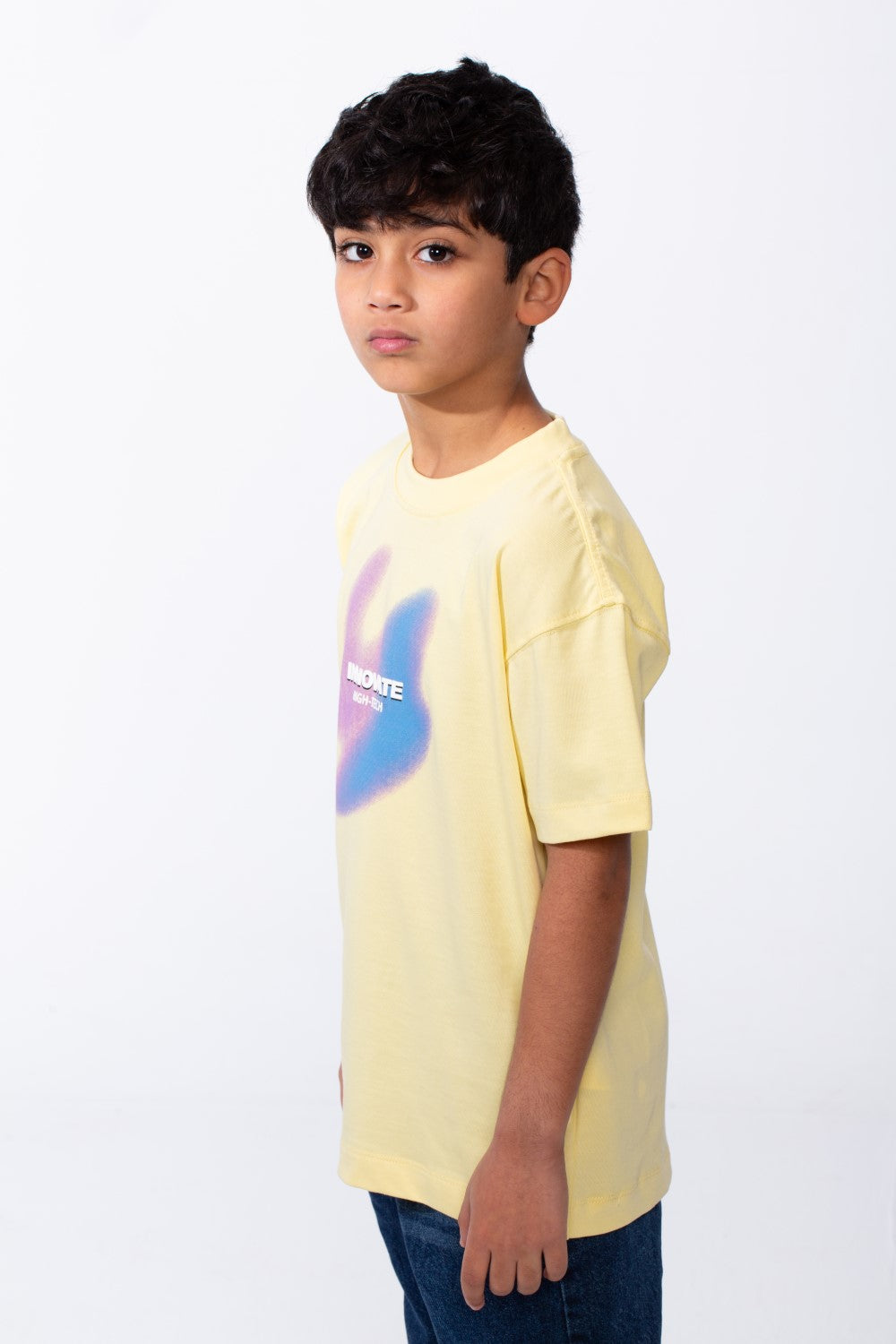 Boy's yellow ribbed crew neck t-shirt with a colorful graphic and typography on the front.