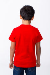 Back view of a boy wearing a red ribbed crew neck t-shirt and blue jeans.